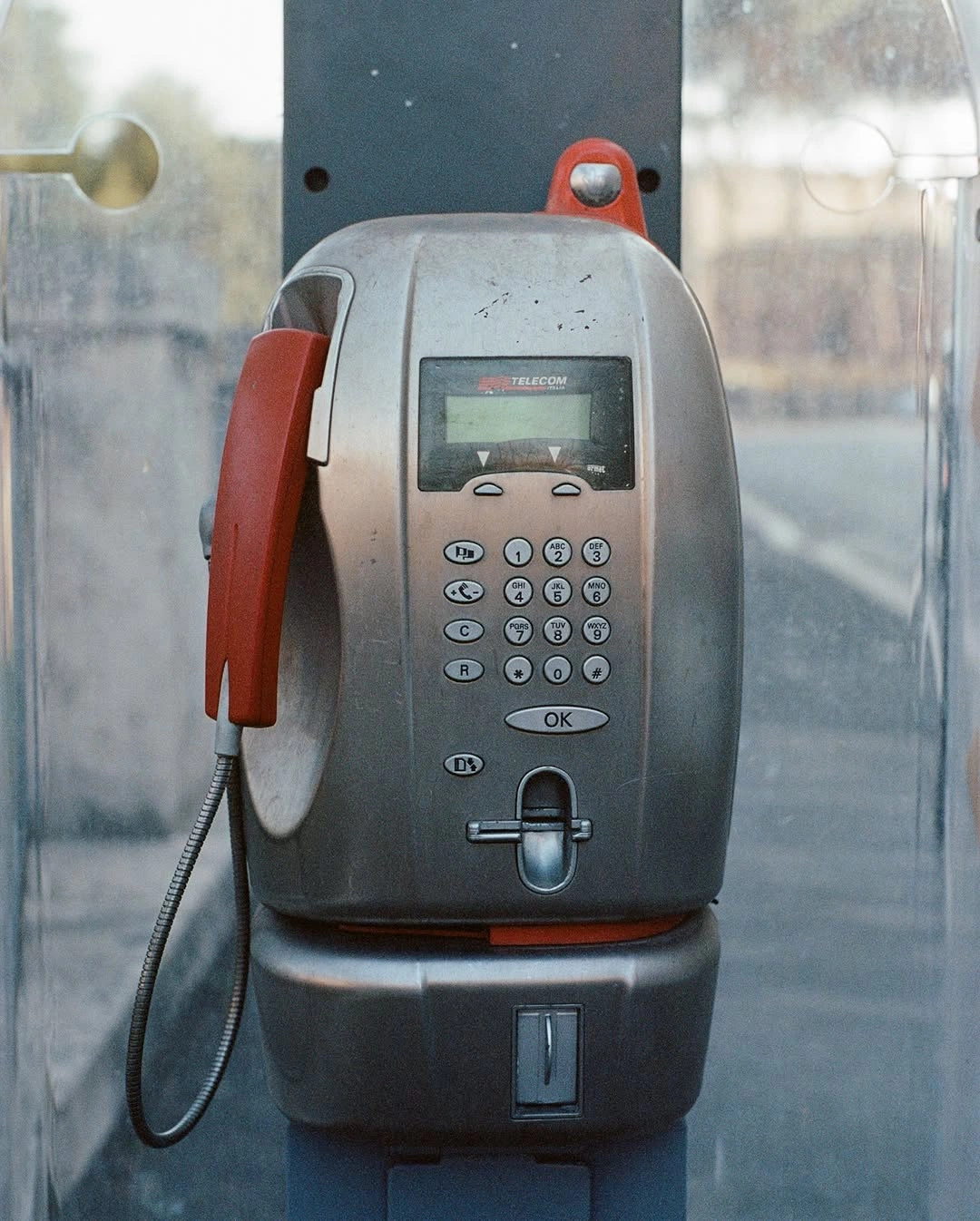 Vintage payphone with a red handset
